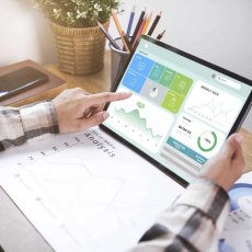 Businesswoman using a tablet to analysis graph company finance s Businesswoman using a tablet to analysis graph company finance strategy statistics success concept and planning for future in office room.